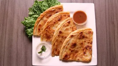 Sliced stuffed flatbread pieces arranged on a white plate
