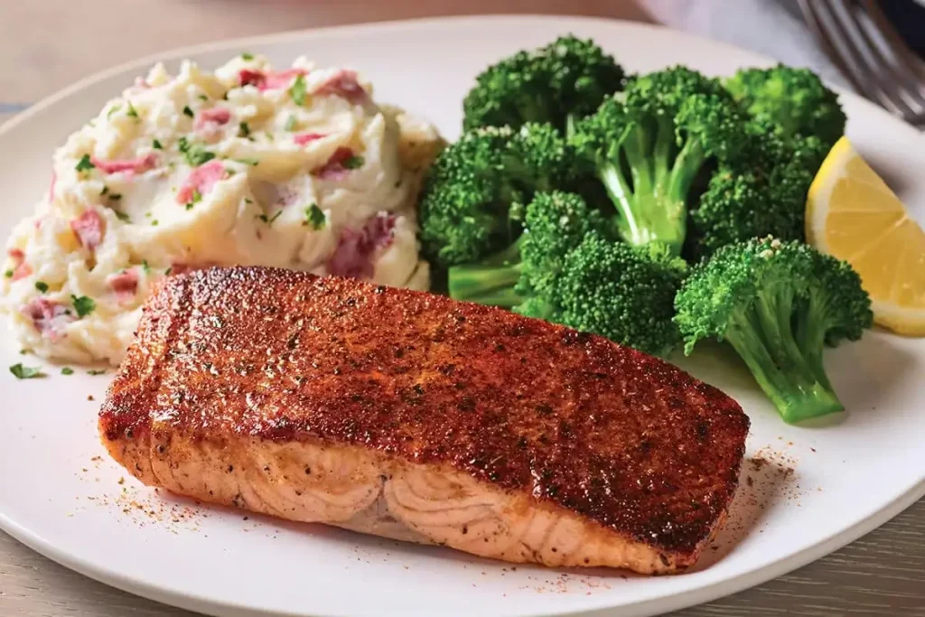 Blackened Cajun salmon fillet served with steamed broccoli
