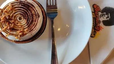 A top-down view of a gourmet chocolate tart with a spiral whipped