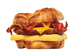 Double cheeseburger with onion rings and cheese on a sesame bun.