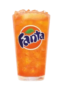 A glass of vibrant orange Fanta soda with ice.
