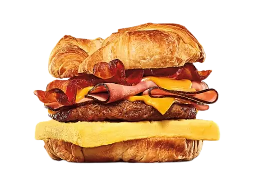 Loaded breakfast croissant with sausage, bacon, ham, and cheese.