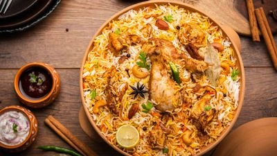 Large clay pot filled with spicy chicken biryani and boiled eggs.