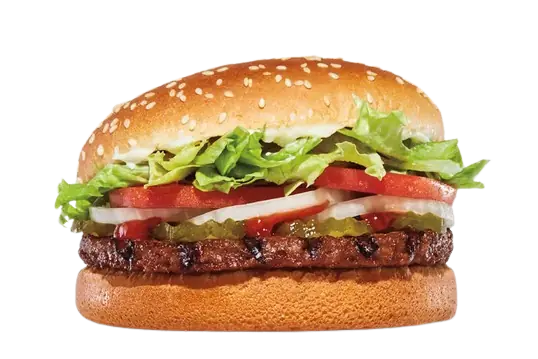 Plant-based burger with fresh salad on a sesame bun.
