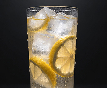 Fresh lemon slices in a frosty glass with ice.