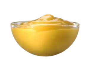 A small clear glass bowl filled with yellow honey mustard dipping sauce.
