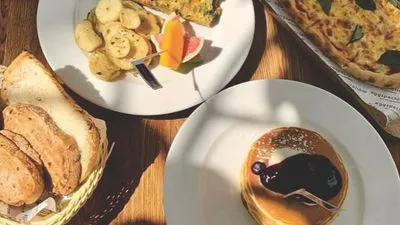 A continental breakfast spread including blueberry pancakes