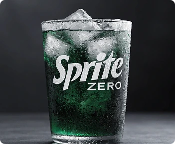 Sprite Zero logo on a cold glass filled with clear soda and ice cubes.