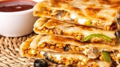 Slices of golden-brown naan stuffed with spicy minced meat and cheese.