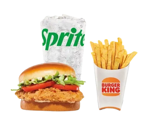 A golden Royal Crispy Chicken sandwich with fresh lettuce and tomatoes, served with a large glass of iced Sprite and French fries.